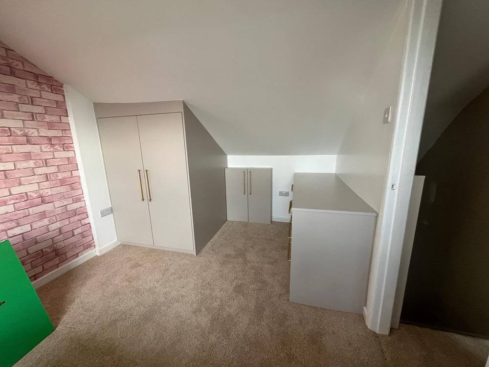 Fitted wardrobe built into a loft eaves space