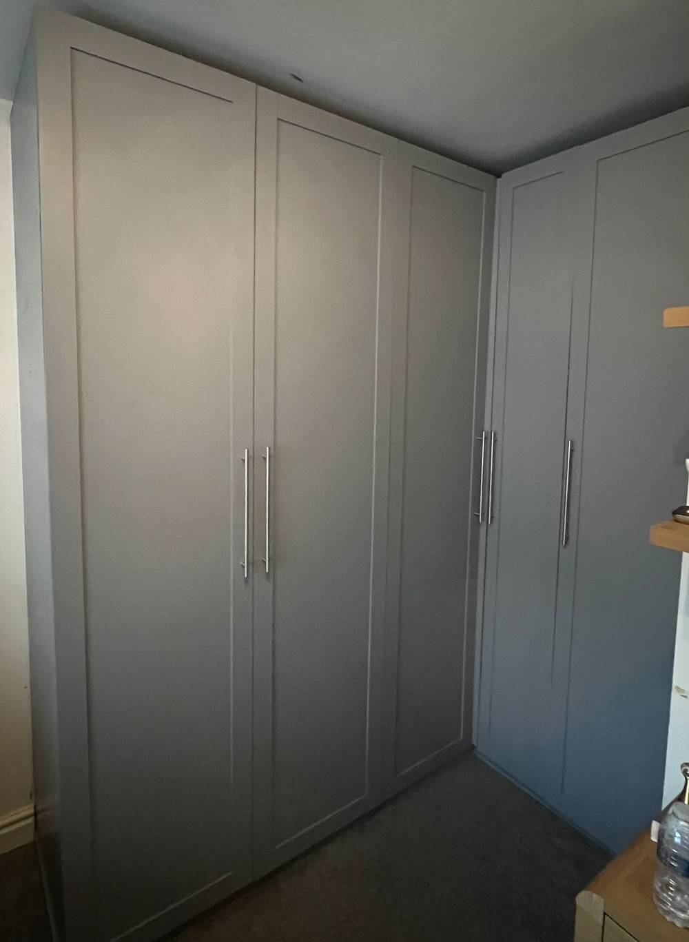Grey fitted wardrobes built around a corner