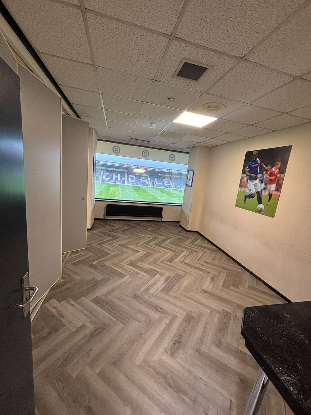 Herringbone flooring fitted in a stadium hospitality suite