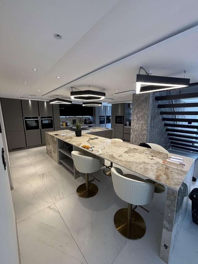 Luxury fitted kitchen with marble island by LMF Joinery