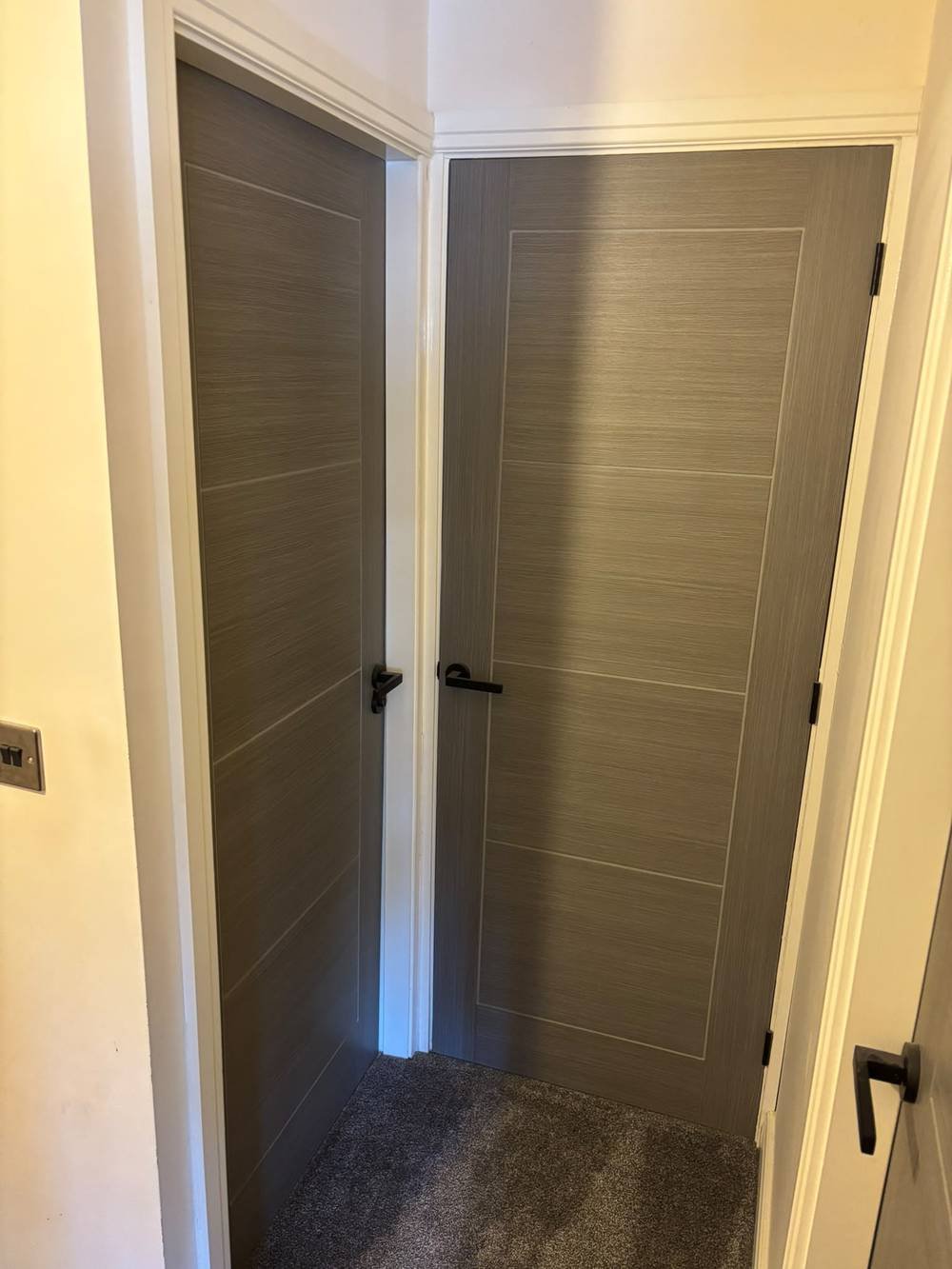 Two grey woodgrain doors fitted side by side